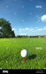 Golf ball on tee Stock Photo - Alamy