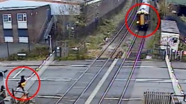 Hair raising moment man narrowly avoids being hit by a train after climbing over level crossing barrier | Daily Mail Online Man... 