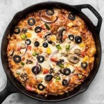 A simple overnight no knead dough makes a perfectly crispy yet thick crust on this no knead pan pizza. Deep dish pan pizz... 