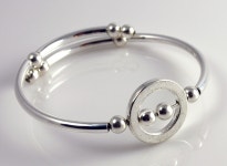 Embraceling Stackable Coil Bracelet with Silver plated Circle. $10.00, via Etsy. | 은 팔찌