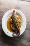 At La Huella restaurant in the fishing village of Jose Ignacio, octopus is seared on the grill and paired with sliced potatoes...