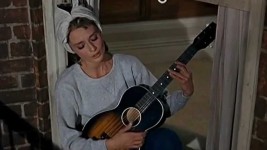 Breakfast at Tiffanys singing and playing the guitar in her apartment window si… | Breakfast at tiffanys movie, Audrey... 