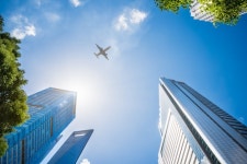 Airplane Flying Over Skyscrapers  Photo | Free Download