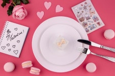 Free Photo | Flat lay of gift box on plate with rose and macarons