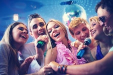 Happy friends singing karaoke together  Photo | Free Download