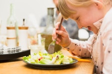 Little girl eating tasty dish  Photo | Free Download