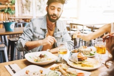 Man eating different dishes of food  Photo | Free Download