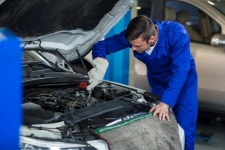 Mechanic servicing a car engine  Photo | Free Download
