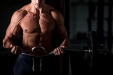 Muscular man lifting a barbell in gym  Photo | Free Download