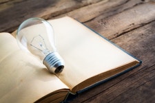 Open book with a light bulb  Photo | Free Download