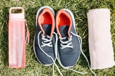 Sneakers between towel and bottle  Photo | Free Download