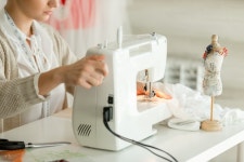 Woman at a sewing machine  Photo | Free Download
