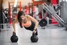 Woman at gym with kettlebells  Photo | Free Download
