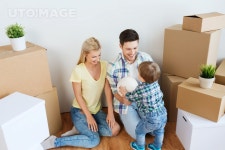 유토이미지 | mortgage, people, housing, moving and real estate concept - happy family with boxes playing ball at new home