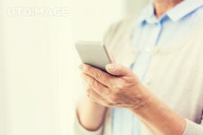 유토이미지 | technology, communication age and people concept - close up of senior woman hands with smartphone texting message... 