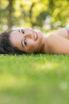 유토이미지 | Stylish cheerful brunette lying on a lawn