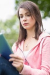 유토이미지 | Serious college girl using tablet PC outdoors