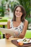 유토이미지 | Woman with tablet PC and meal in the cafeteria