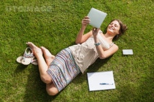 유토이미지 | Female student using tablet PC at the park