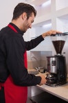 Happy barista grinding coffee beans | 유토이미지 | 상세페이지 | 베이직샵 | 16832346