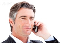 유토이미지 | Smiling businessman talking on the phone 유토이미지 | Smiling businessman talking on the phone 