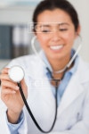 유토이미지 | Gorgeous female doctor using a stethoscope while looking at the camera