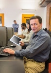 유토이미지 | Mature student in computer class holding tablet pc