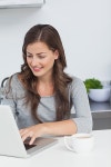 유토이미지 | Woman using her laptop pc in the kitchen