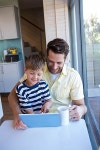 Father and son using tablet pc in the living room at home | 유토이미지 | 상세페이지 | 베이직샵 | 사진 | 19564240