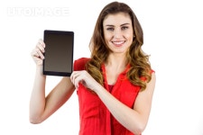 유토이미지 | Pretty brunette showing tablet pc on white background