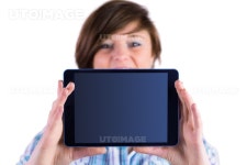 유토이미지 | Pretty brunette showing tablet pc on white background