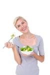 유토이미지 | Happy blonde woman holding bowl of salad