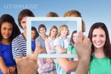 유토이미지 | Hand holding tablet pc against park on sunny day