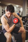 유토이미지 | Fit man lifting heavy black dumbbell at the gym