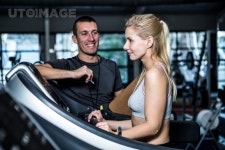 유토이미지 | Fit woman with trainer using treadmill at gym