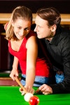 유토이미지 | Couple (man and woman) in a billiard hall playing snooker
