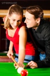 유토이미지 | Couple (man and woman) in a billiard hall playing snooker