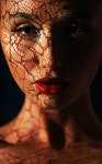유토이미지 | Reflection. Woman in Shadows with Reflection of Openwork Lace on her Face