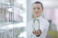 유토이미지 | Happy cheerful pharmacist chemist woman standing in pharmacy drugstore