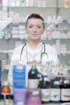 유토이미지 | Happy cheerful pharmacist chemist woman standing in pharmacy drugstore
