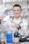 유토이미지 | Happy cheerful pharmacist chemist woman standing in pharmacy drugstore