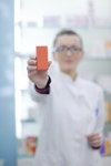 유토이미지 | Happy cheerful pharmacist chemist woman standing in pharmacy drugstore