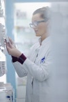 유토이미지 | Happy cheerful pharmacist chemist woman standing in pharmacy drugstore