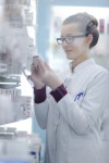 유토이미지 | Happy cheerful pharmacist chemist woman standing in pharmacy drugstore