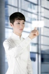 유토이미지 | futuristic businesswoman finger touch pad on modern office