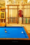 유토이미지 | Billiard club with blue pool table cue in a row and winner trophy