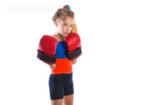 유토이미지 | boxer kid blond girl with funny boxing gloves on white background