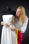 유토이미지 | Woman tailor working on dress