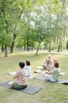Group of calm mature people focused on meditation sitting with crossed legs on mats in summer park | 유토이미지 | 상세페이지... 
