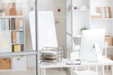 유토이미지 | Background image of modern office interior with PC on workplace in cubicle separated by glass walls, copy space